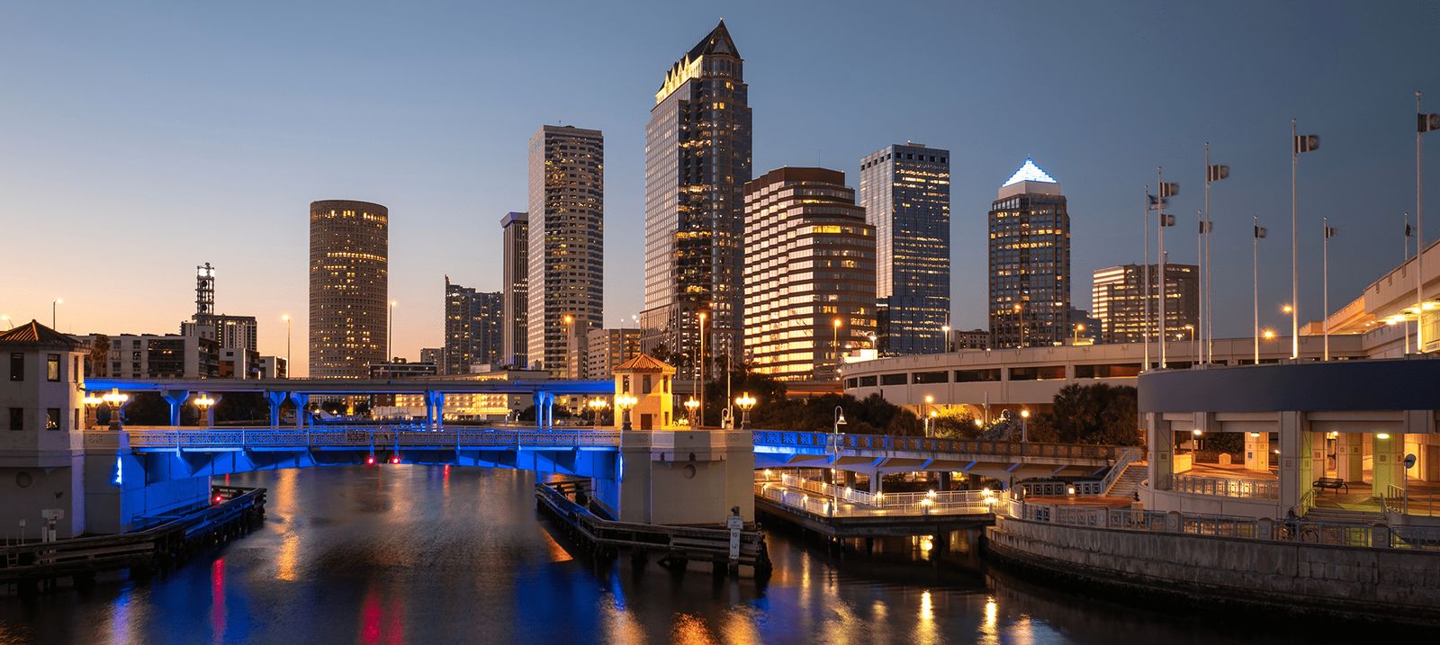 City skyline at dusk, illuminated buildings